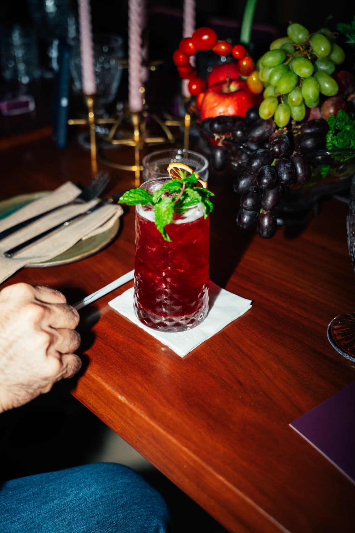 Signature red cocktail served on the table at Alura